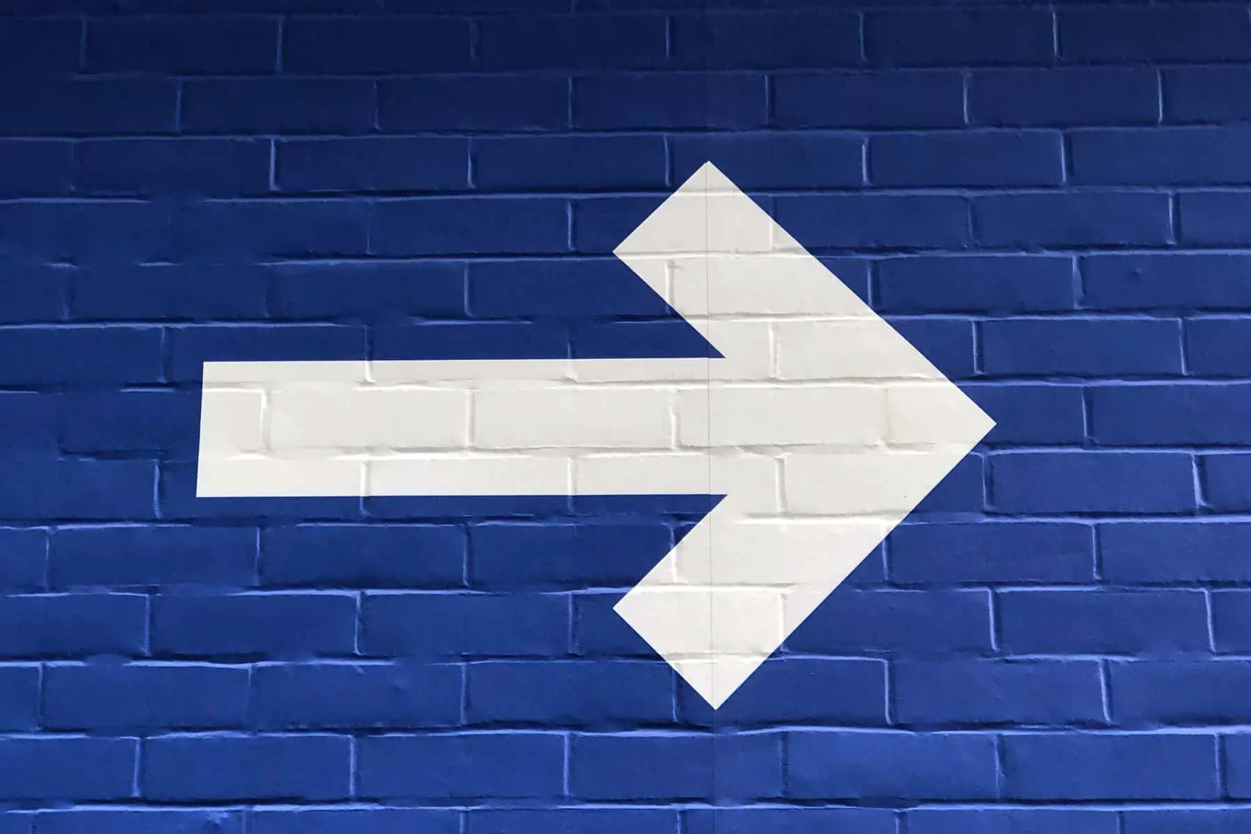 Blue wall with white arrow