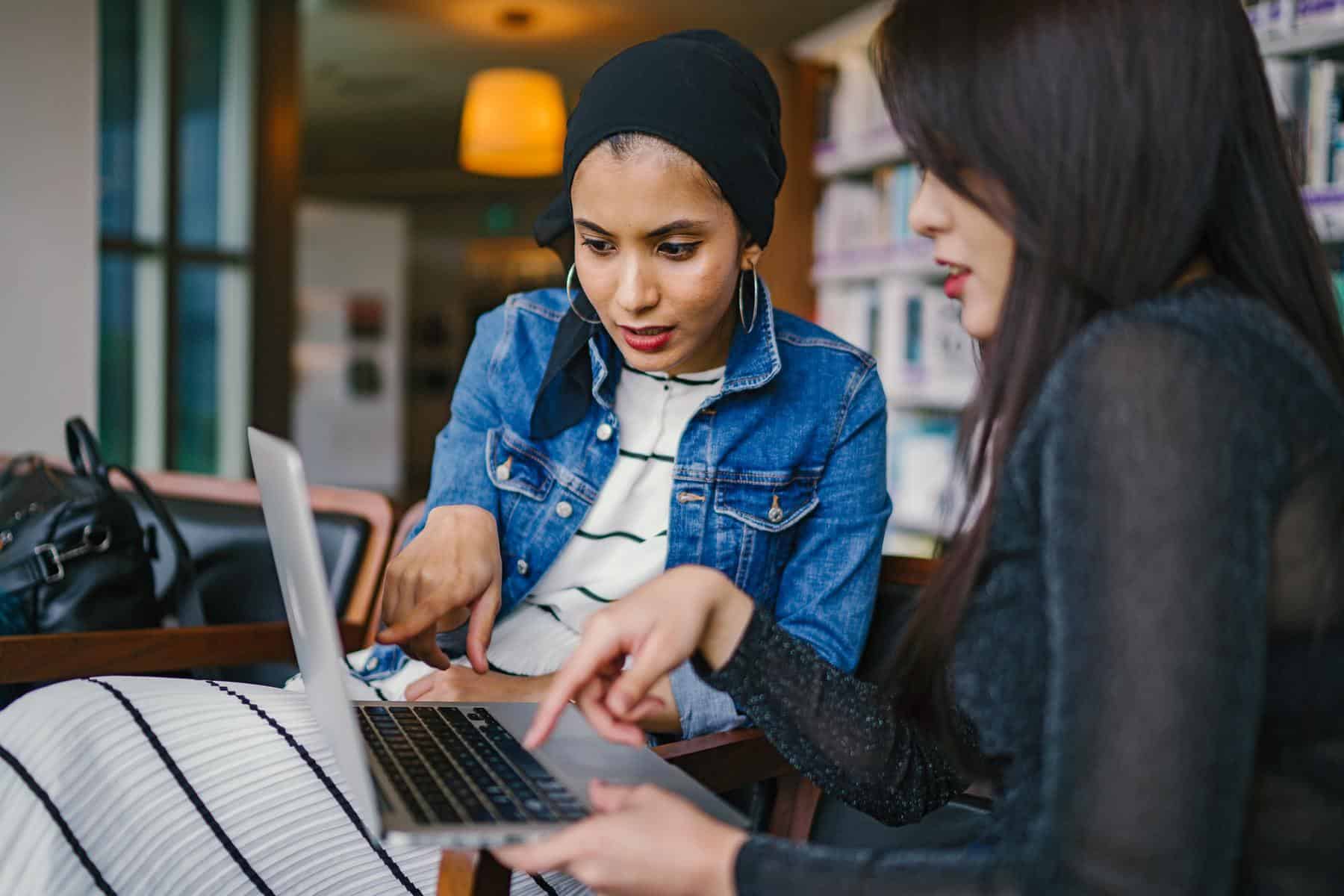 Woman pointing at a laptop