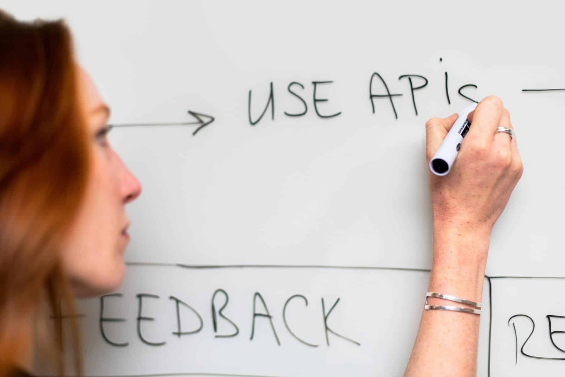 Woman writing on whiteboard