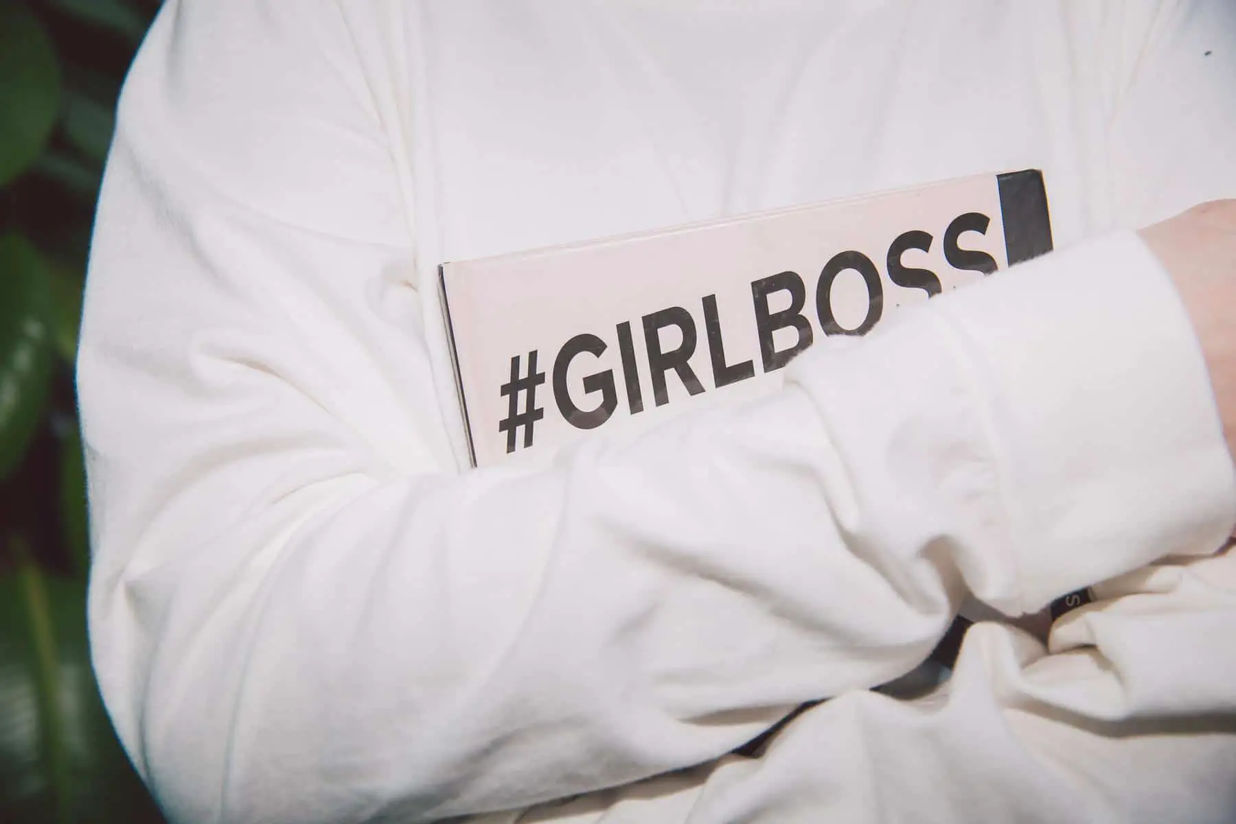 Person holding notebook with girlboss hashtag