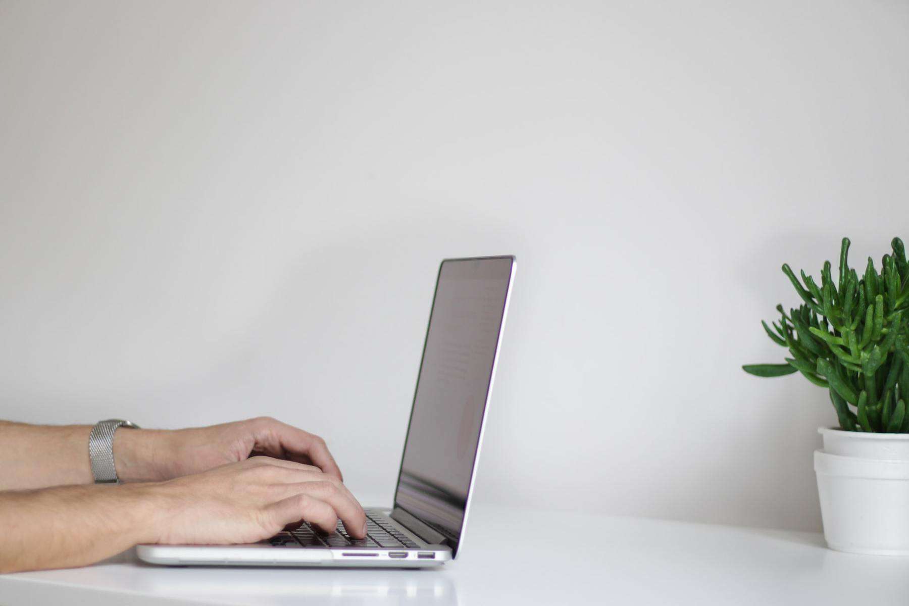 Person working with laptop on desk