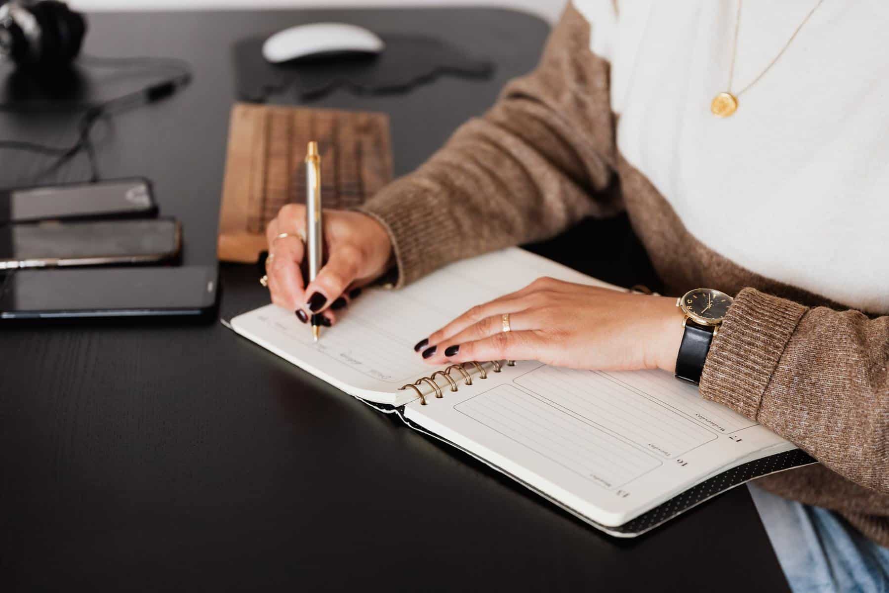 Woman writing in notebook