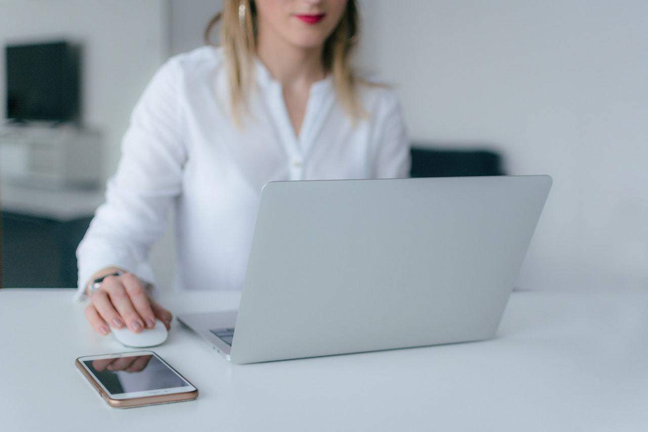 Woman using laptop and PC mouse 