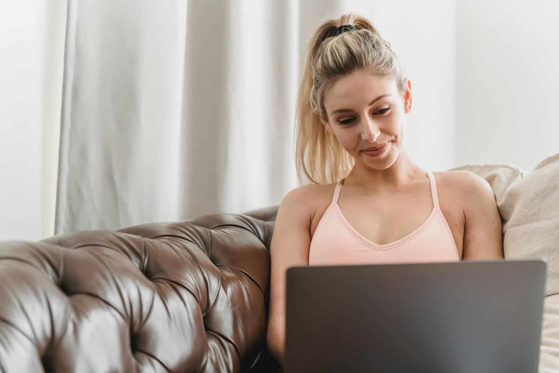 Young woman smiling at laptop